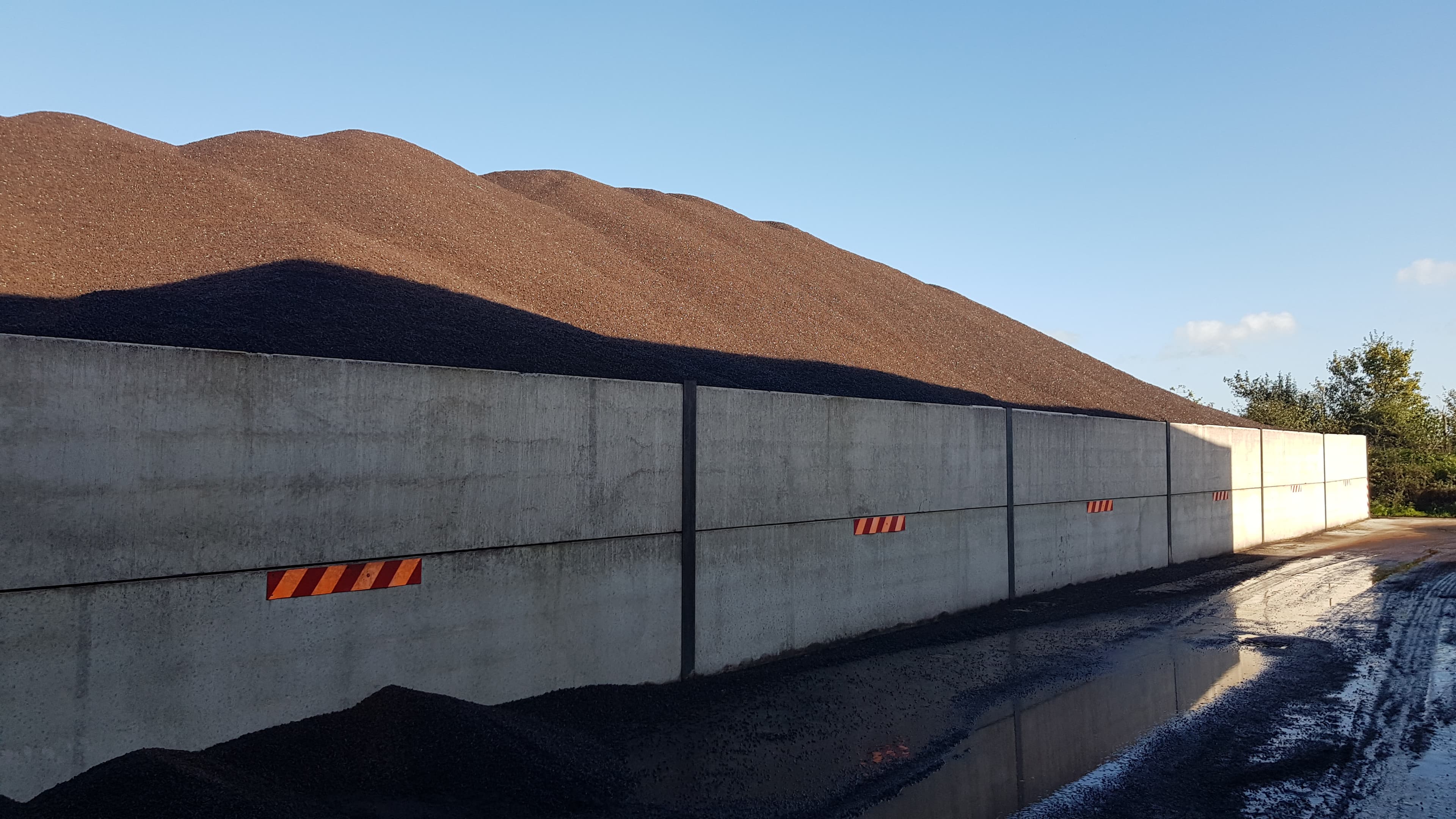 Lignin pellets stored outside at a destination port after coaster shipment