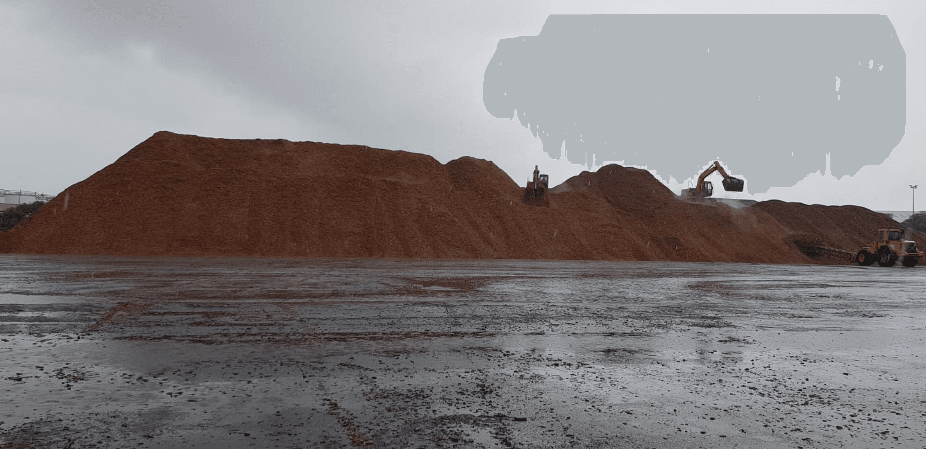 Woodchip stockpiles at an Irish port-side yard.