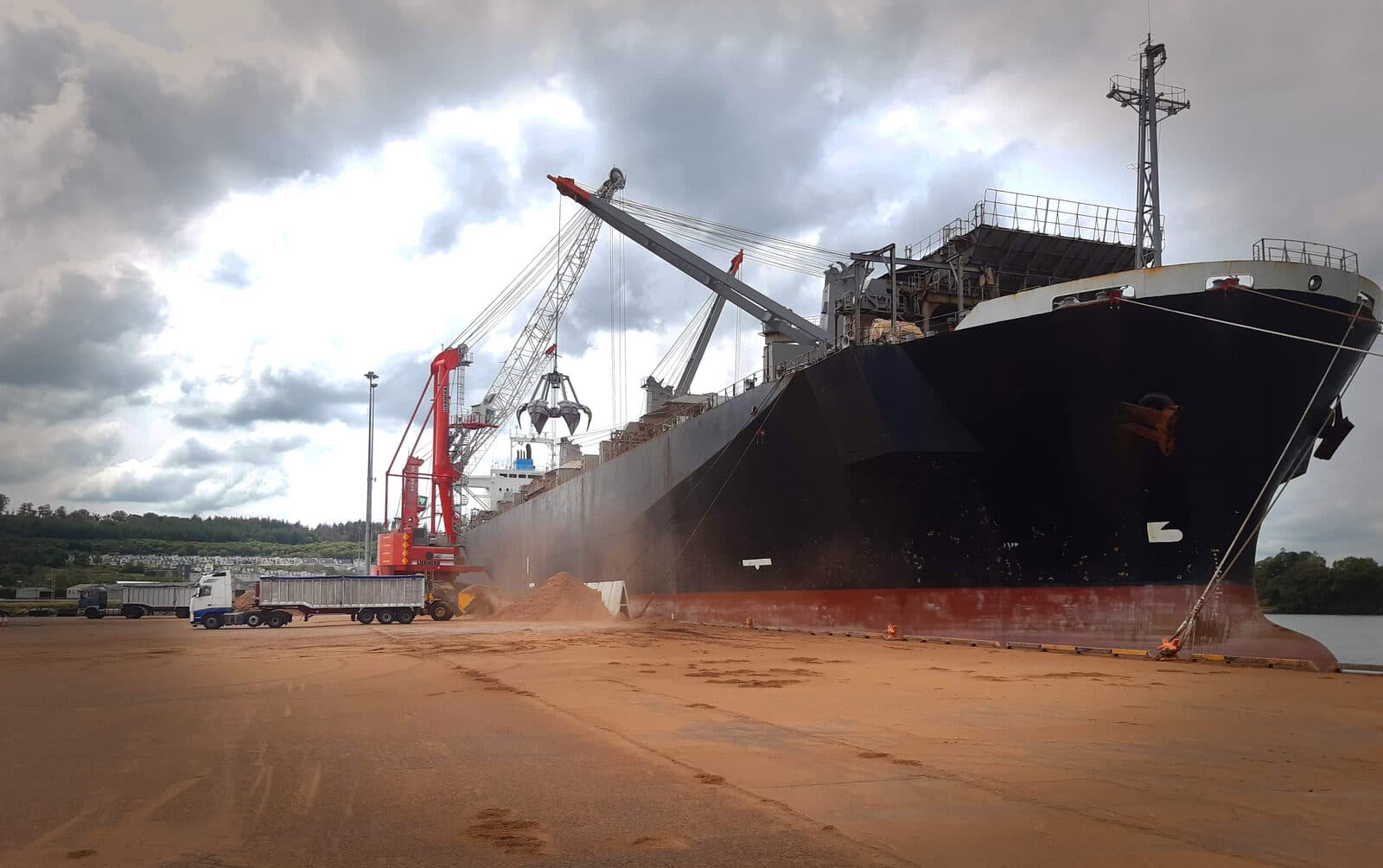Bulk vessel at Foynes quayside during biomass discharge and port handling.